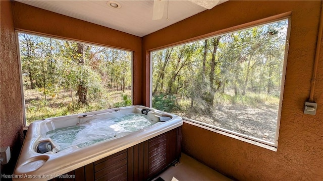 sunroom with a jacuzzi