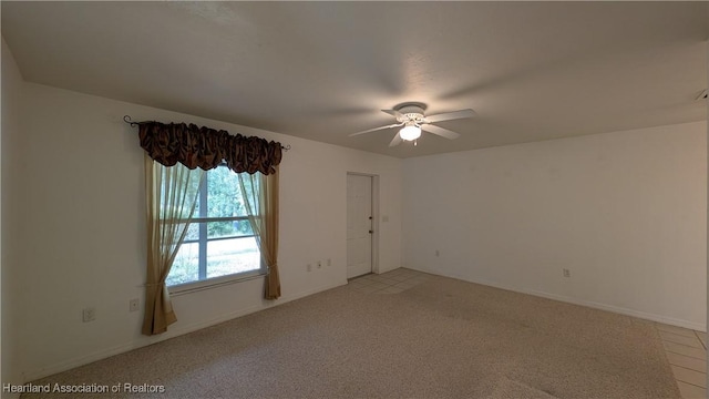 unfurnished room with light carpet, ceiling fan, and baseboards