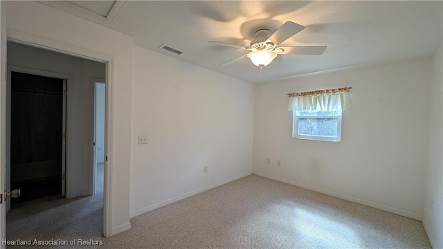 unfurnished room featuring visible vents, ceiling fan, and baseboards