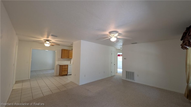 unfurnished living room with light carpet, visible vents, and a ceiling fan