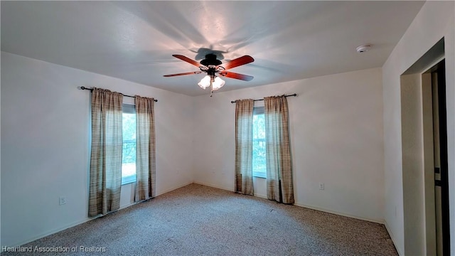 unfurnished room featuring carpet and ceiling fan