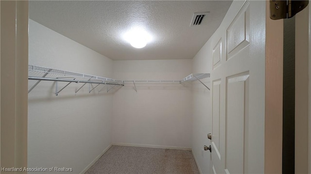 spacious closet featuring carpet floors and visible vents