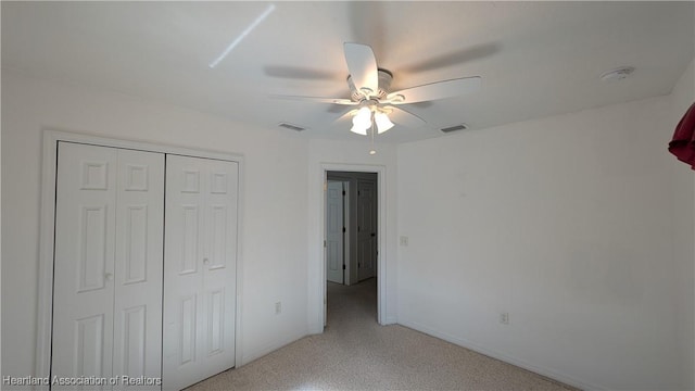 unfurnished bedroom with light carpet, a closet, visible vents, and a ceiling fan