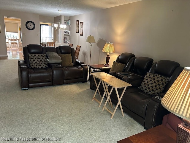 living room featuring carpet, a chandelier, and a textured ceiling