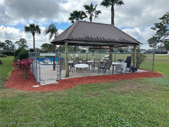 surrounding community featuring a yard, a patio, a gazebo, and fence