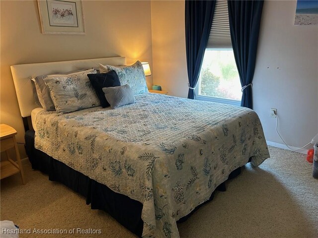 carpeted bedroom featuring baseboards