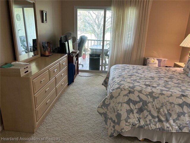 bedroom with light carpet and access to outside