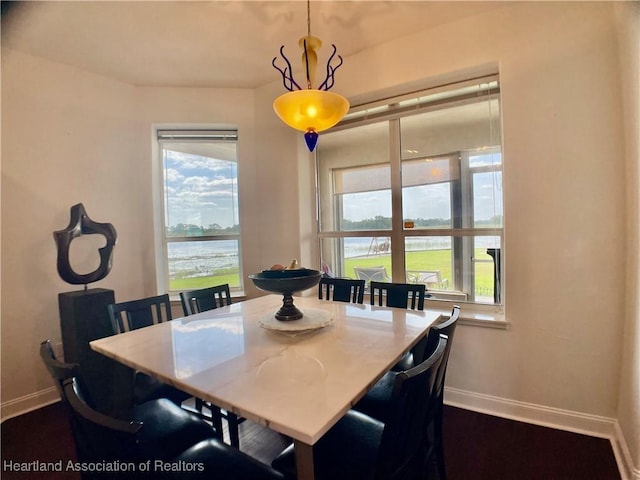 dining room with dark wood finished floors and baseboards