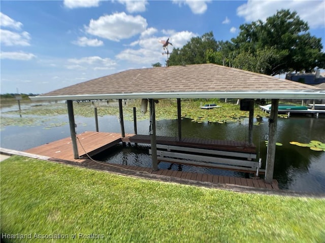 dock area with boat lift and a water view