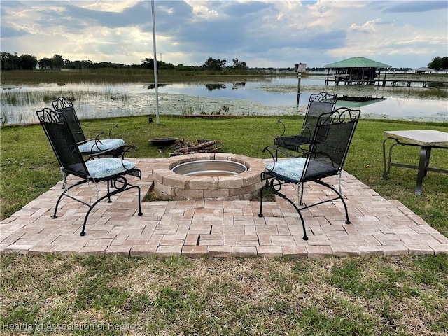 view of patio featuring a water view and an outdoor fire pit