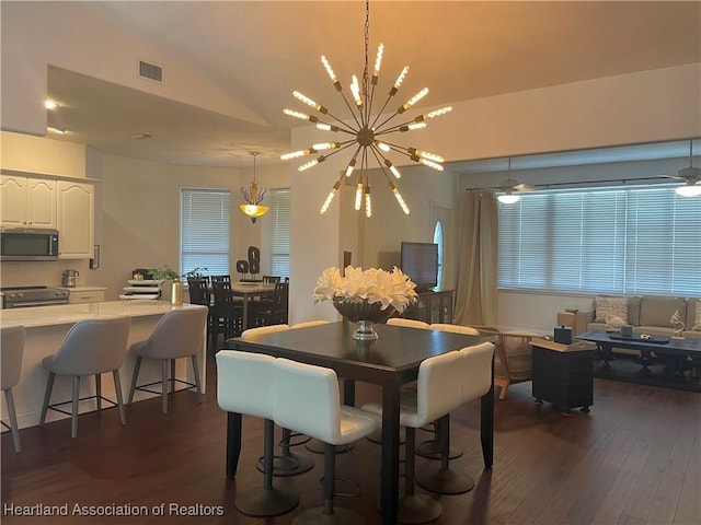 131 Temptation Ct, Lake Placid, FL 33852 - dining space with lofted ceiling, dark wood-style floors, and a chandelier