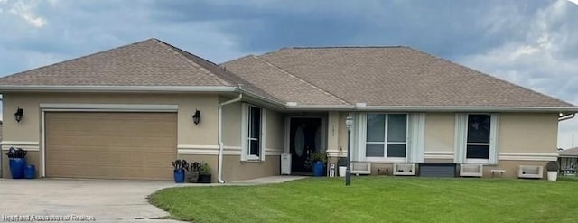 ranch-style house with a garage and a front yard