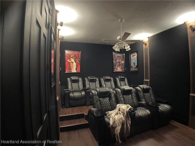 cinema room with wood finished floors and ceiling fan