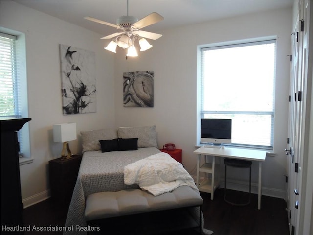 bedroom with baseboards and wood finished floors