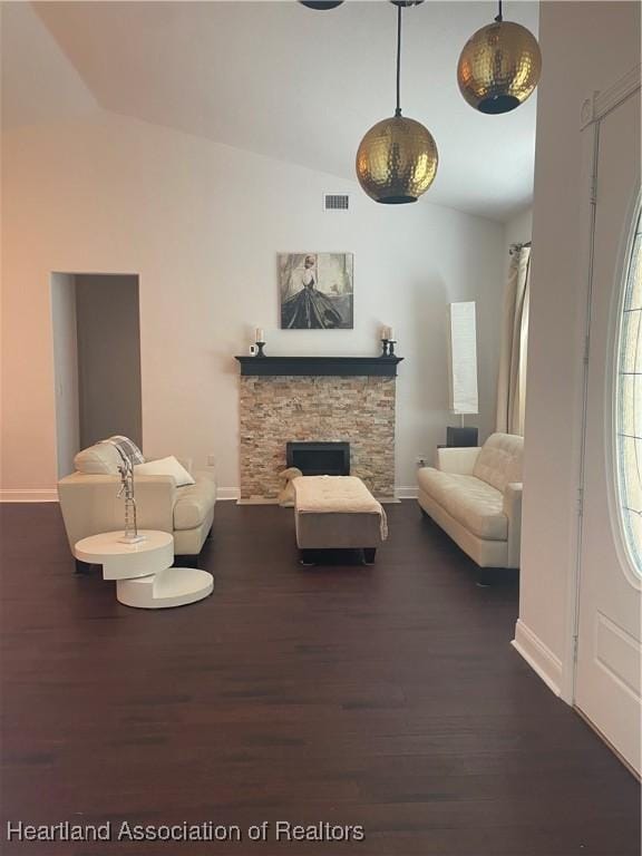 131 Temptation Ct, Lake Placid, FL 33852 - living room featuring baseboards, dark wood-type flooring, a stone fireplace, and high vaulted ceiling