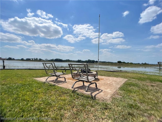 view of yard with a patio area and a water view