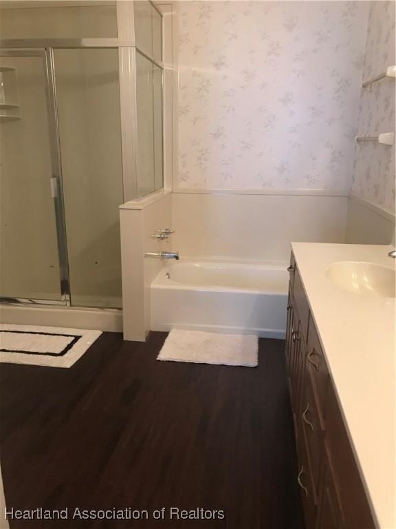 bathroom featuring vanity, wood-type flooring, and separate shower and tub