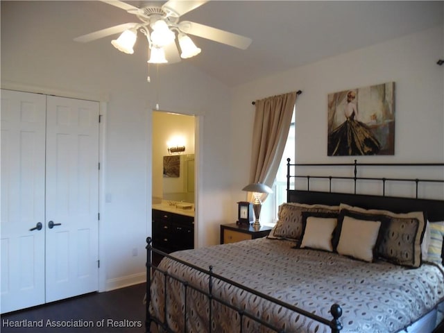 bedroom with lofted ceiling, connected bathroom, ceiling fan, a closet, and dark wood-type flooring