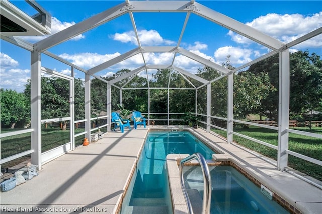 view of swimming pool featuring a lanai and a patio