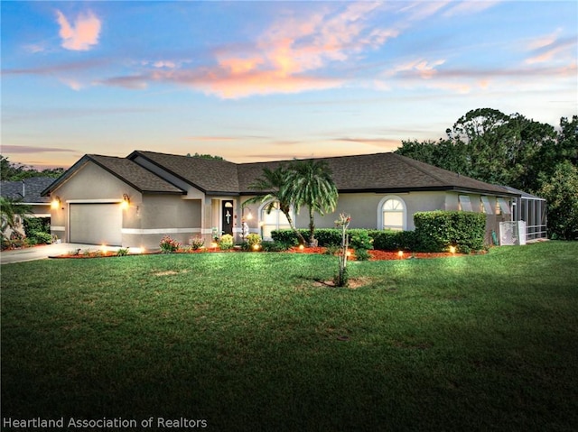 view of front of property with a lawn and a garage