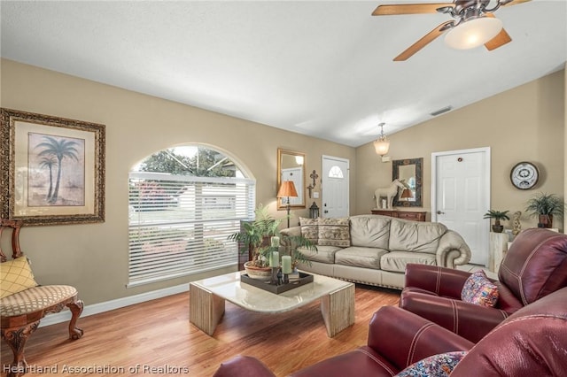 living room featuring lofted ceiling, ceiling fan, and light wood-type flooring