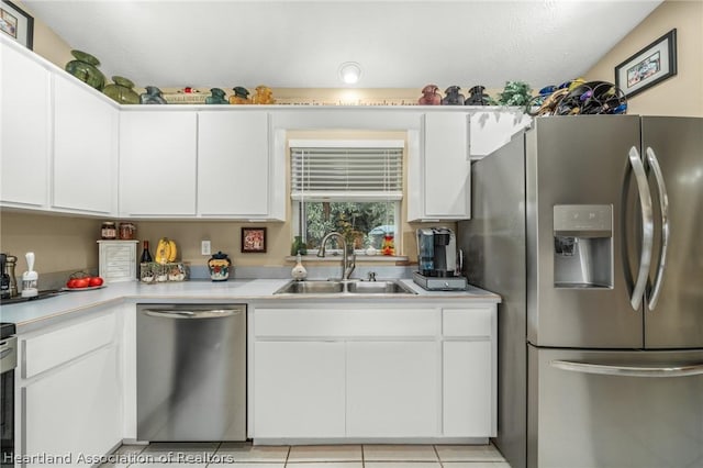 kitchen featuring appliances with stainless steel finishes, white cabinetry, and sink