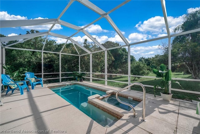 view of swimming pool with a lanai, a patio area, and an in ground hot tub