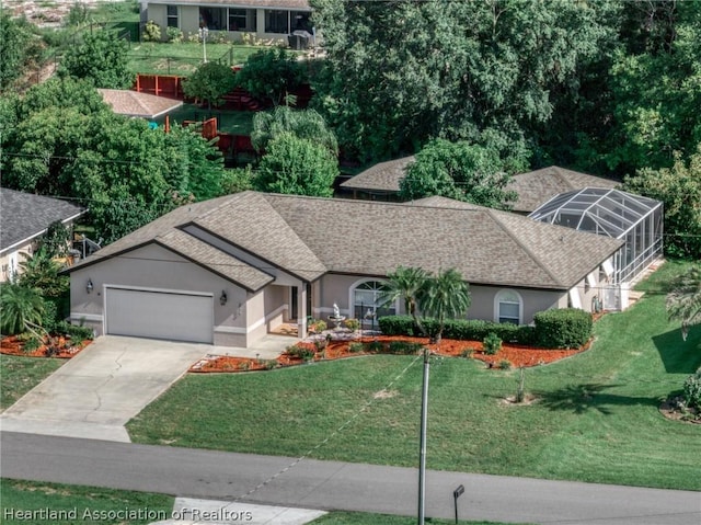 view of front of home with glass enclosure, a garage, and a front lawn