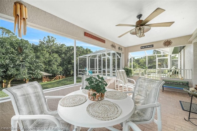 sunroom featuring ceiling fan