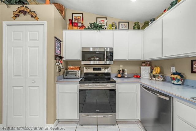 kitchen featuring white cabinets, light tile patterned flooring, and appliances with stainless steel finishes