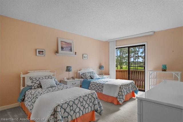 carpeted bedroom featuring a textured ceiling and access to outside