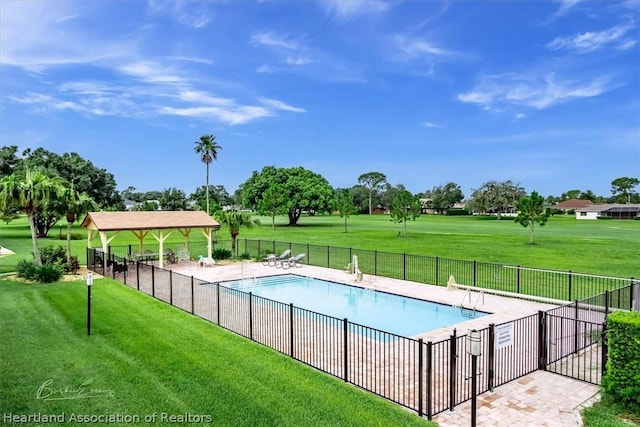 view of swimming pool with a gazebo and a yard