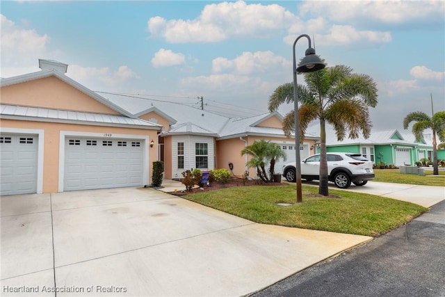 ranch-style home featuring a front lawn and a garage