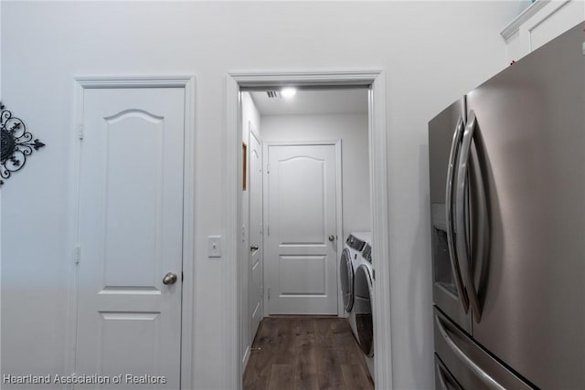 laundry room featuring washer and clothes dryer and dark wood-type flooring