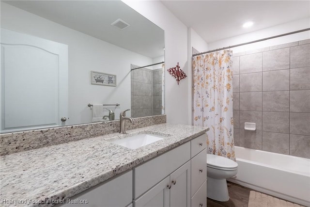 full bathroom featuring toilet, wood-type flooring, vanity, and shower / bathtub combination with curtain