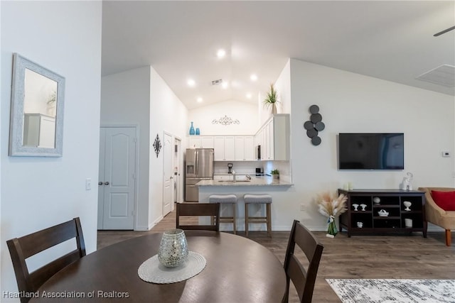 dining space with lofted ceiling and dark hardwood / wood-style flooring