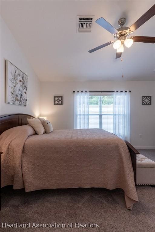 carpeted bedroom with vaulted ceiling and ceiling fan