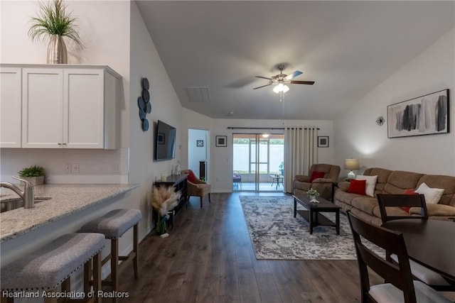 living room featuring sink, ceiling fan, vaulted ceiling, and dark hardwood / wood-style floors