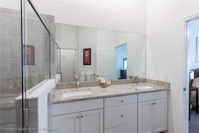 bathroom featuring an enclosed shower and vanity