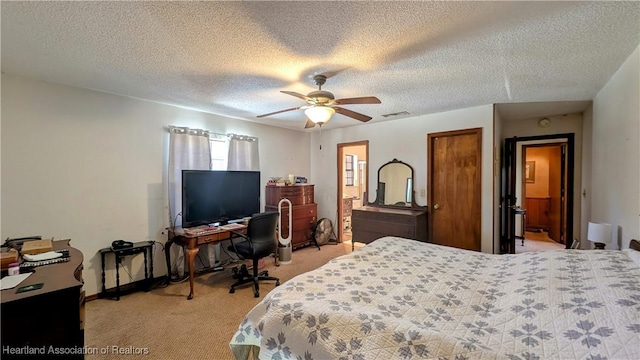 carpeted bedroom with ceiling fan and a textured ceiling