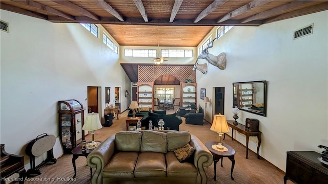 living room featuring beam ceiling, carpet floors, wood ceiling, and a towering ceiling