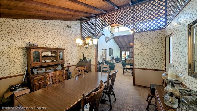 carpeted dining area featuring beam ceiling, a notable chandelier, wood ceiling, and a towering ceiling