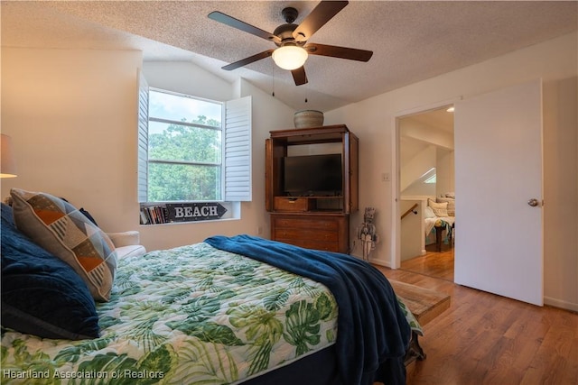 751 Grenada St, Port St Lucie, FL 34983 - bedroom featuring wood finished floors, lofted ceiling, a textured ceiling, and a ceiling fan