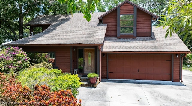 751 Grenada St, Port St Lucie, FL 34983 - view of front facade featuring a shingled roof, concrete driveway, and an attached garage