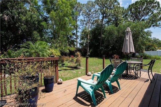751 Grenada St, Port St Lucie, FL 34983 - wooden deck with a yard, outdoor dining area, and view of scattered trees
