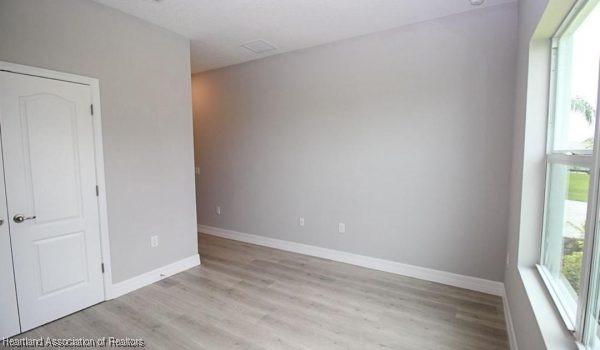 empty room with a healthy amount of sunlight and light hardwood / wood-style floors