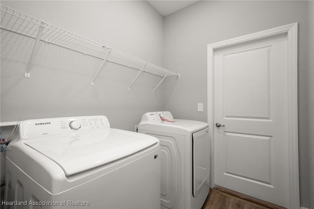 laundry room featuring dark wood-type flooring and washing machine and clothes dryer