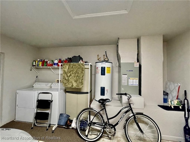 clothes washing area with heating unit, laundry area, crown molding, electric water heater, and independent washer and dryer
