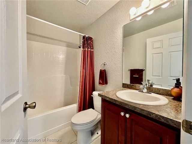full bathroom featuring toilet, shower / tub combo with curtain, tile patterned floors, vanity, and a textured wall