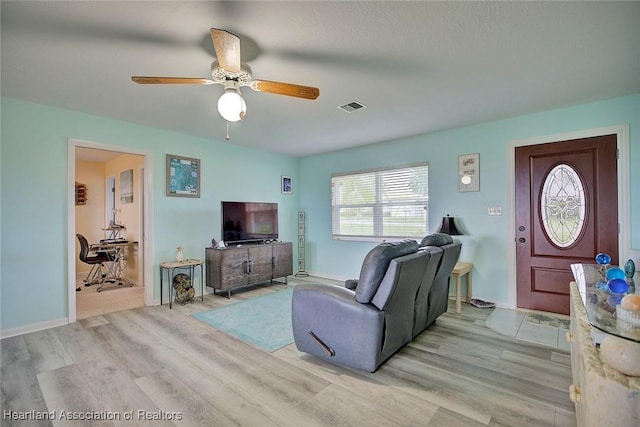 living room with light hardwood / wood-style floors and ceiling fan